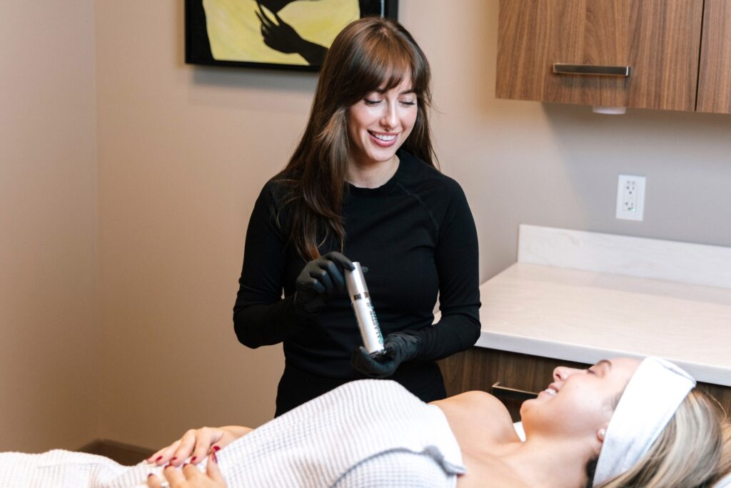 Kelsey McKillop, LME medical esthetician at BOYD Med Spa, performing a Hydrafacial treatment on a patient in Metro Detroit